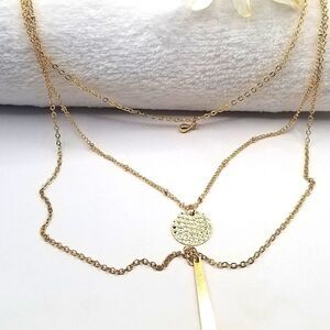 Gold toned layered chain pendant necklace.
